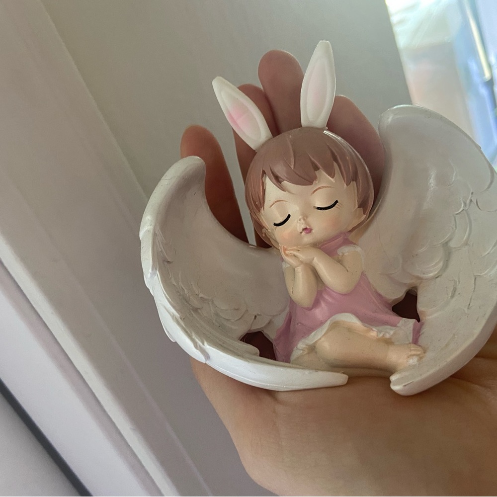 Girl baby angle figurine with rabbit hat